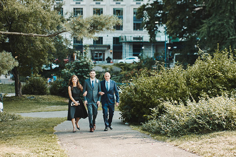 Groom walking down the aisle with parents