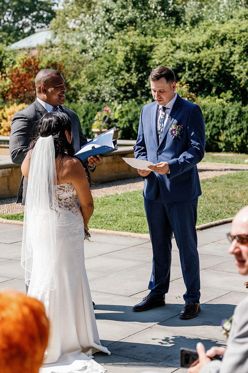 Groom reading personal wedding vows