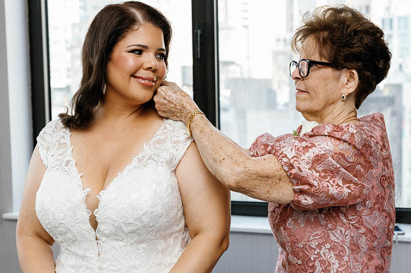 Mother helping bride get ready