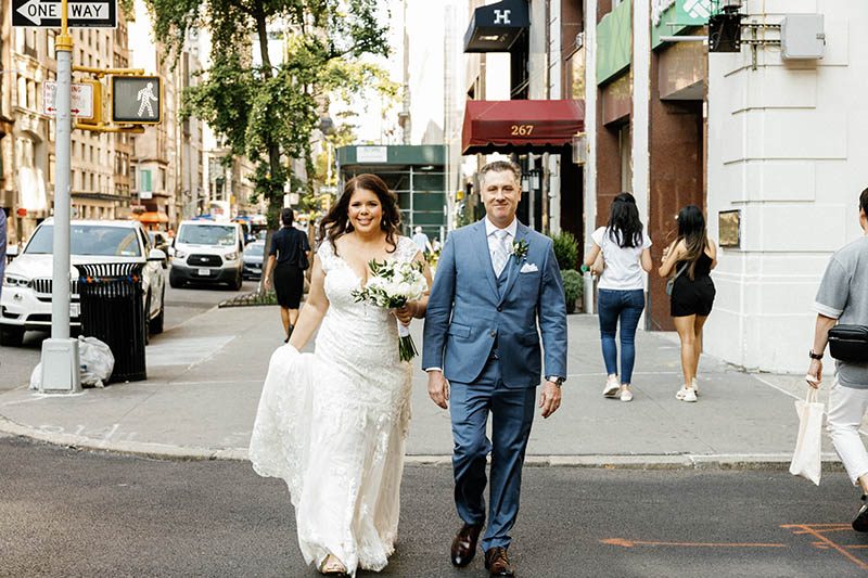Bride and groom crossing the street