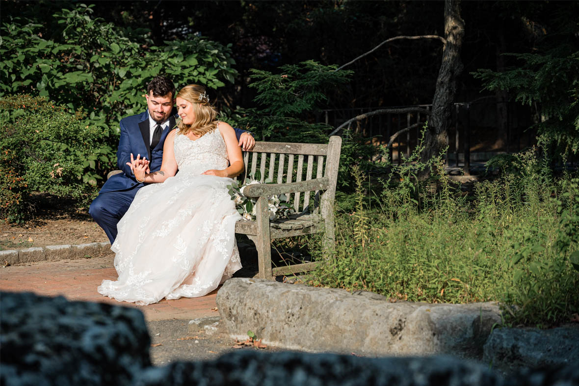 Bride and groom sitting on bench