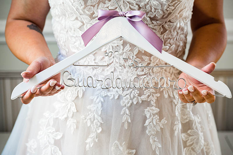 Bride holding custom hanger