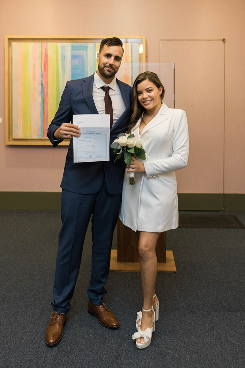 Couple holding marriage certificate