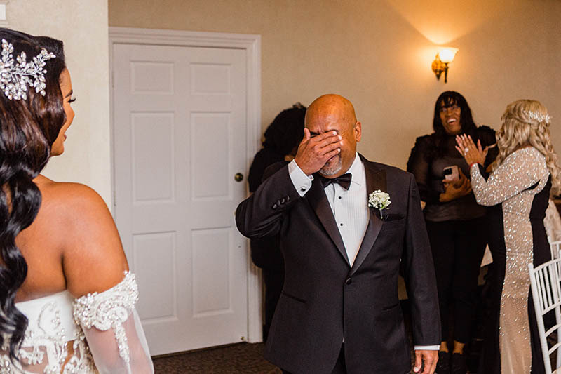 Father crying seeing daughter for the first time in wedding dress
