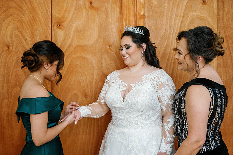 Maid of honor helping bride get ready