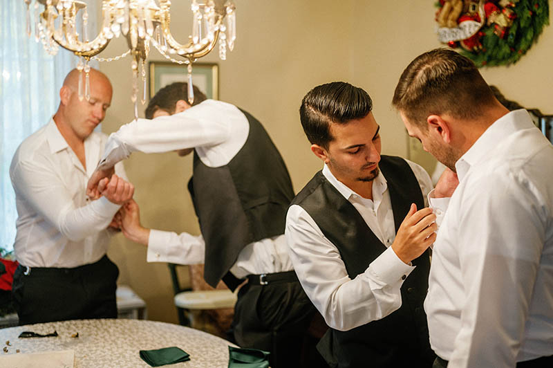 Groomsmen helping each other get ready