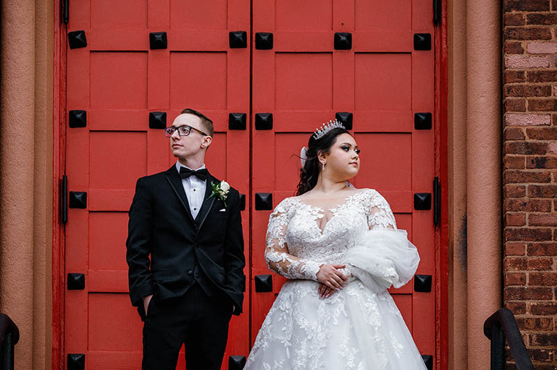 Wedding portrait in front of red church door