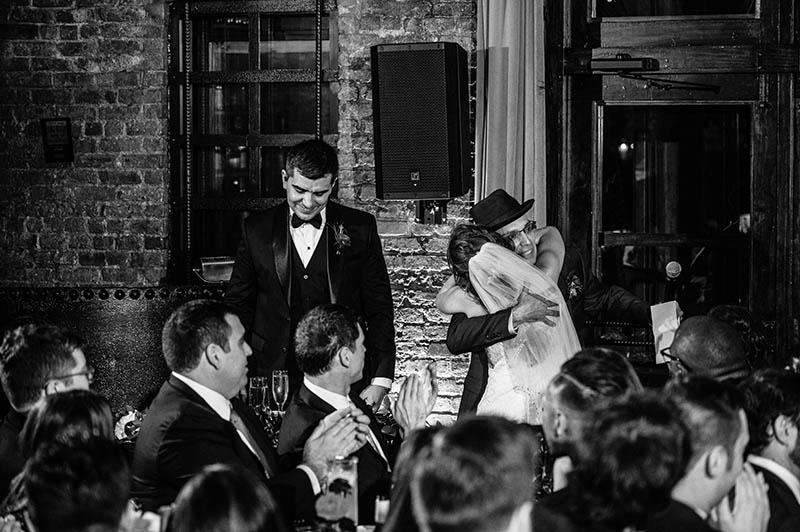 Bride hugging father after toast