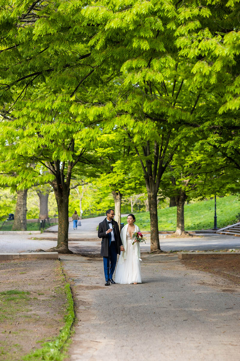 Bride and groom walk in the park