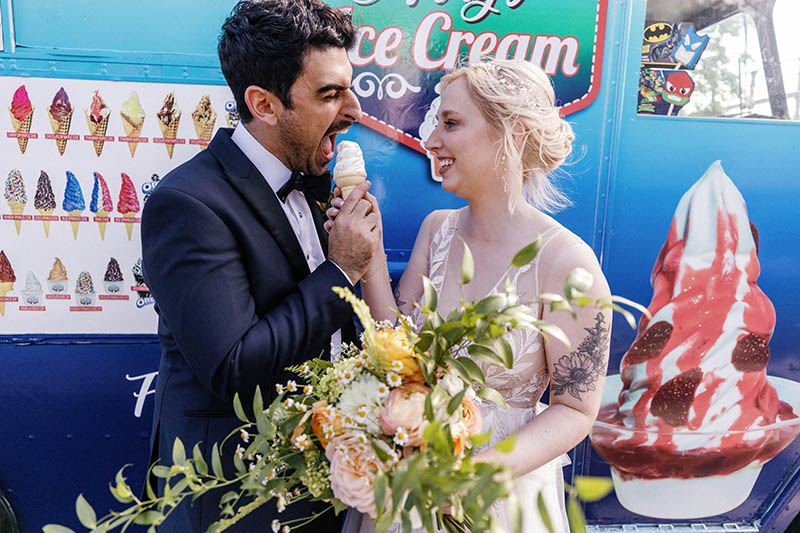 Bride and groom eating ice cream