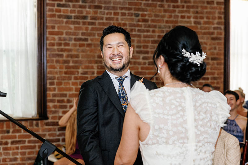 Groom laughing at wedding ceremony